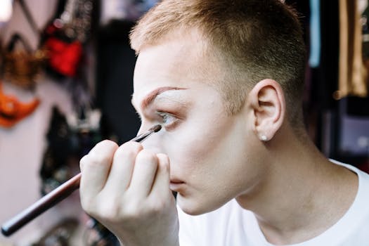 A drag performer carefully applies makeup in the dressing room, preparing for a show.