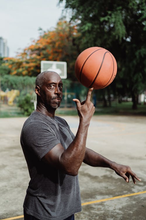 Man in Gray Crew Neck T-shirt Holding Basketball