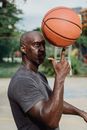 Man in Gray Crew Neck T-shirt Holding Basketball
