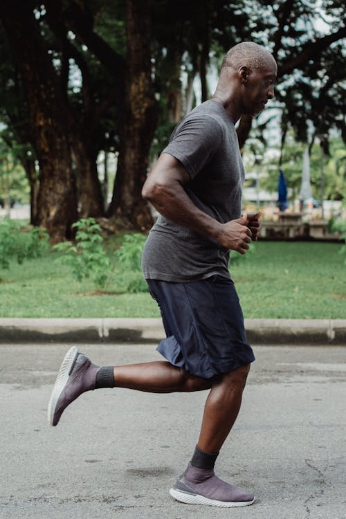 Free Man in Gray T-shirt and Blue Shorts Running Stock Photo