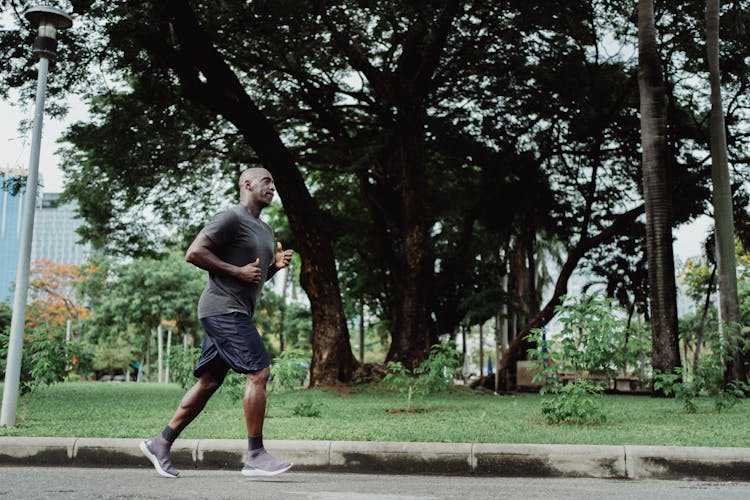 Man In Gray T-shirt And Black Shorts Running