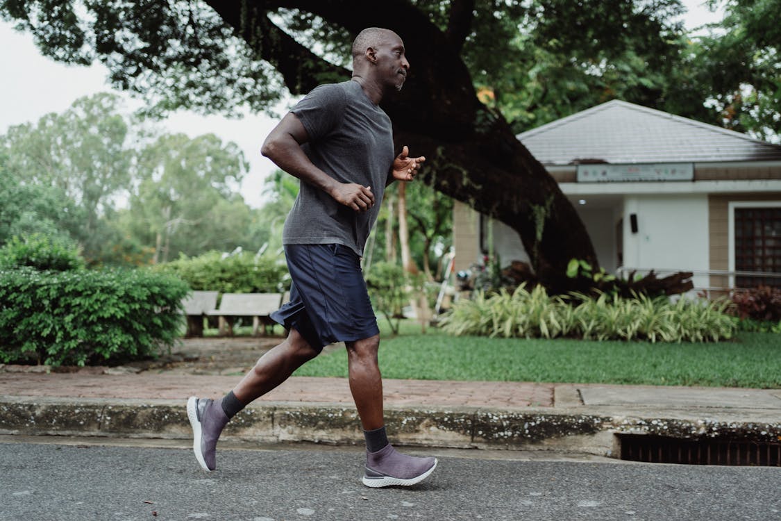 Man in Gray T-shirt and Black Shorts Running