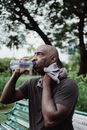 Man in Black Crew Neck T-shirt Drinking Water from Bottle