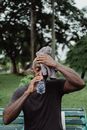 Man in Black Shirt Drinking Water from Plastic Bottle