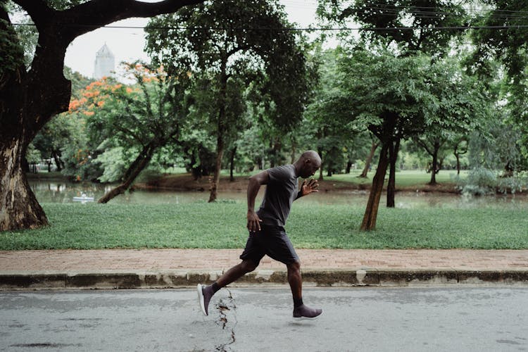 Man In Gray T-shirt And Black Shorts Running