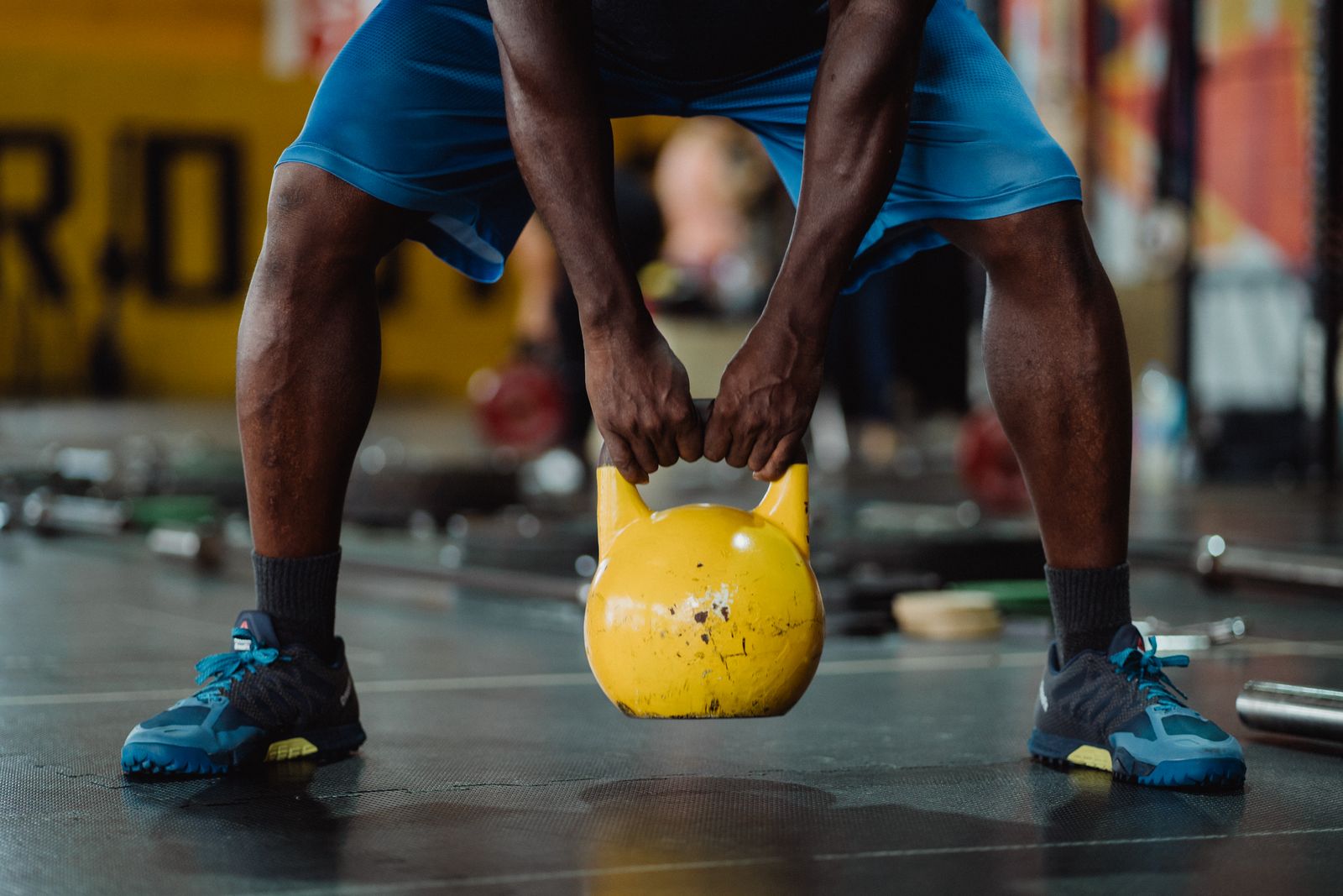 Athlete preparing for kettlebell training in a bright workout space