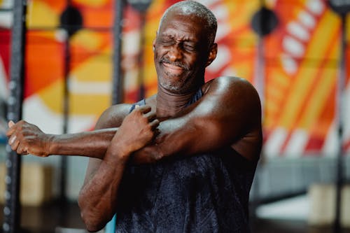 Shallow Focus Photo of Man Stretching