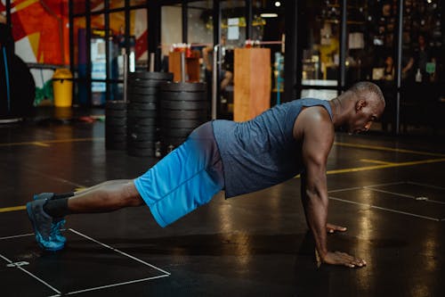 Man in Blue Shorts Doing Push-Ups