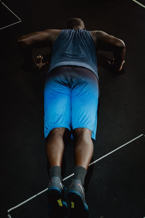 Man in Blue Shorts Doing Push-Ups