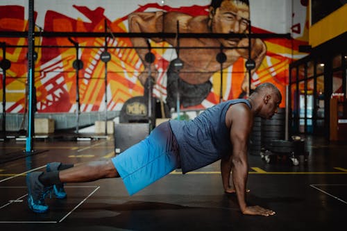 Free Man in Gray Tank Top Doing Push-Ups Stock Photo