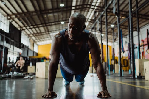 Man in Gray Tank Top Doing Push Up