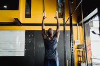 Back View of Man Exercising on Gym