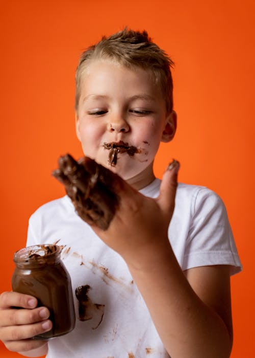 Free Photo Of Boy Enjoying Melted Chocolate Stock Photo
