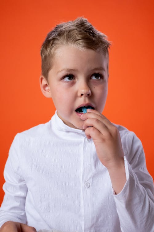 Boy in White Dress Shirt With Blue Pacifier