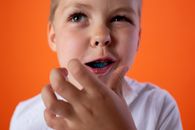 Boy in White Shirt With Orange Background