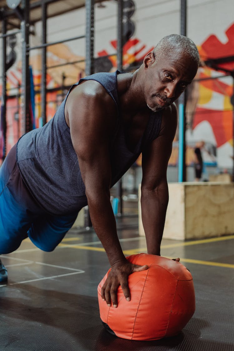 Man Using An Orange Gym Ball 