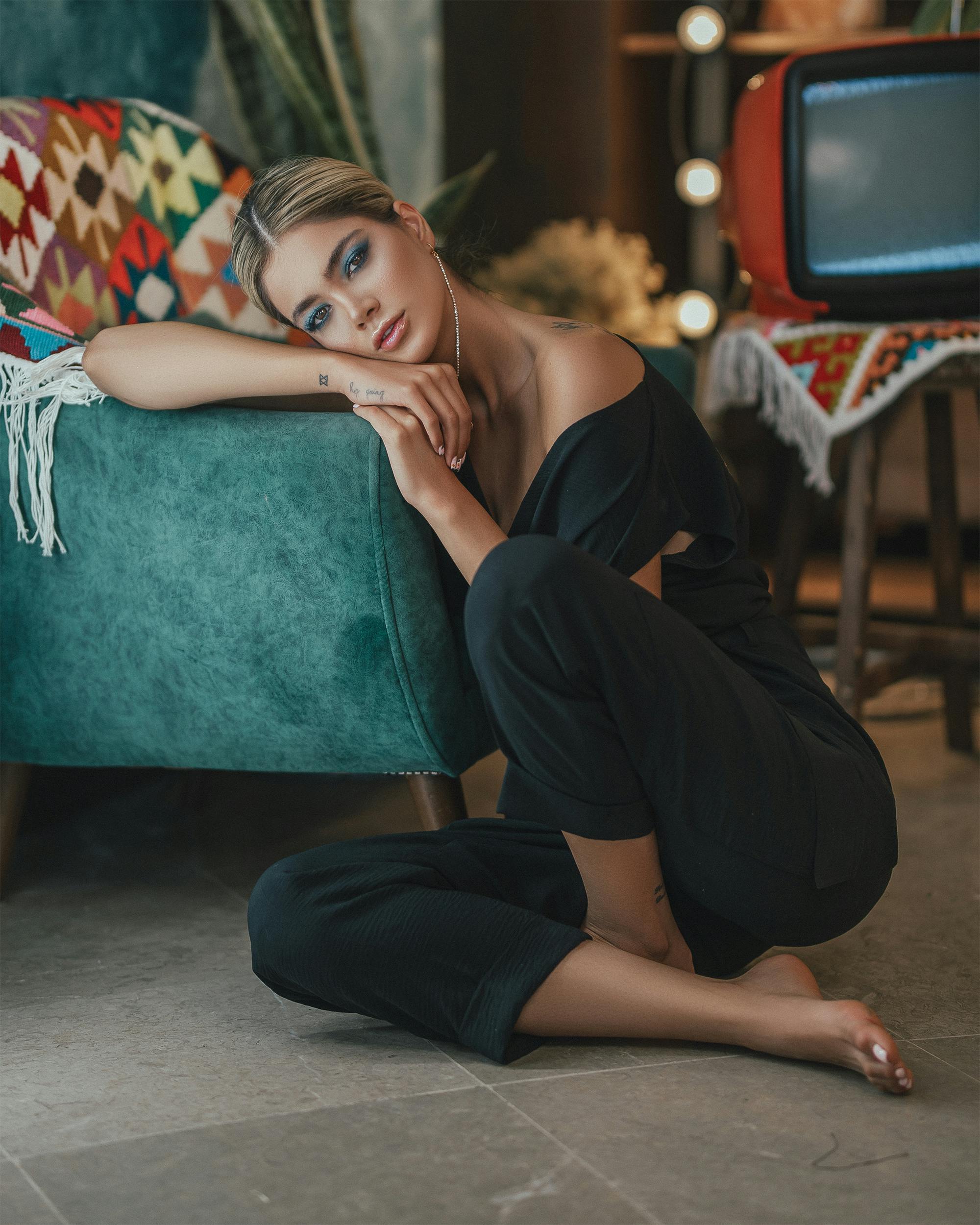 attractive woman sitting on floor in room