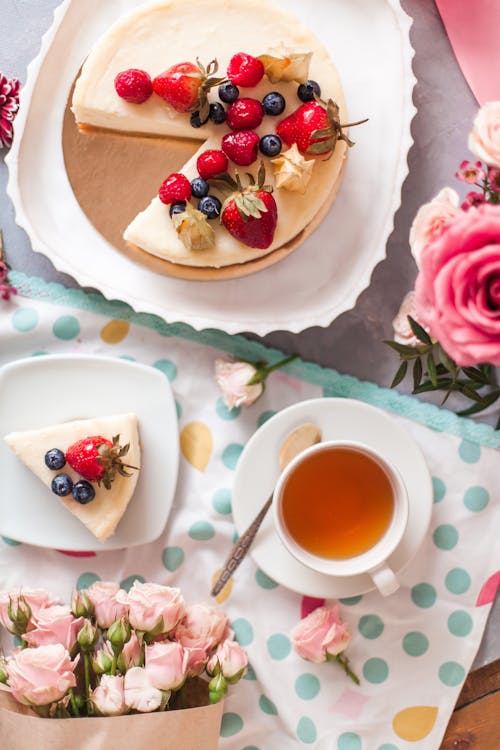 Appetizing cake and delicate bouquets of roses