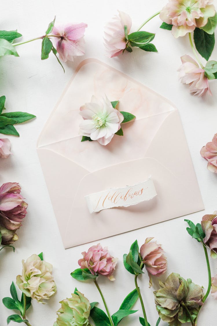 Delicate Flower Corolla On Surface Of Envelope Surrounded By Flowers