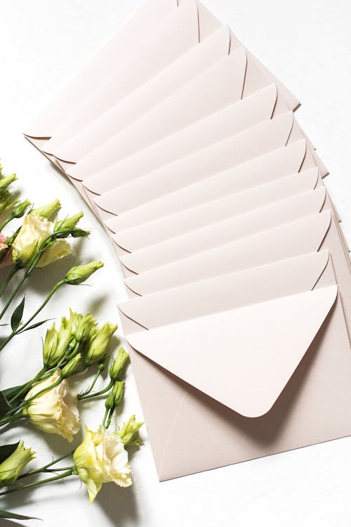 Free Envelopes with bouquet of delicate flowers Stock Photo