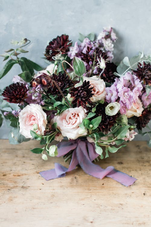 Bouquet of flowers placed on wooden table