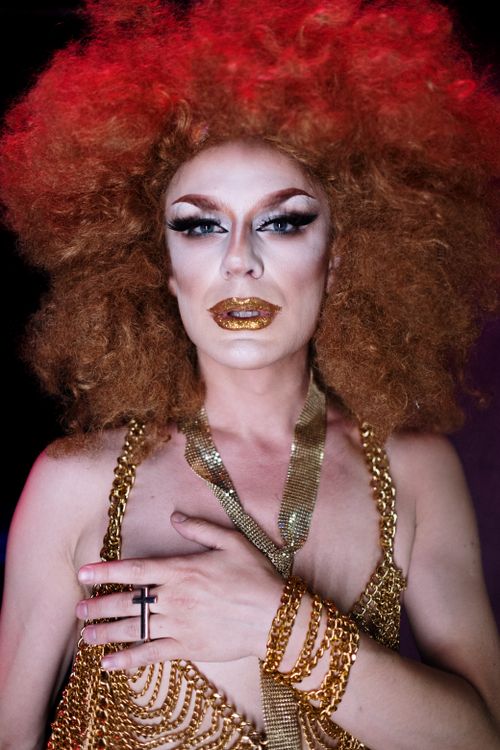 Free Portrait of a drag queen wearing glamorous makeup and a stylish costume, embodying a confident and powerful persona. Stock Photo