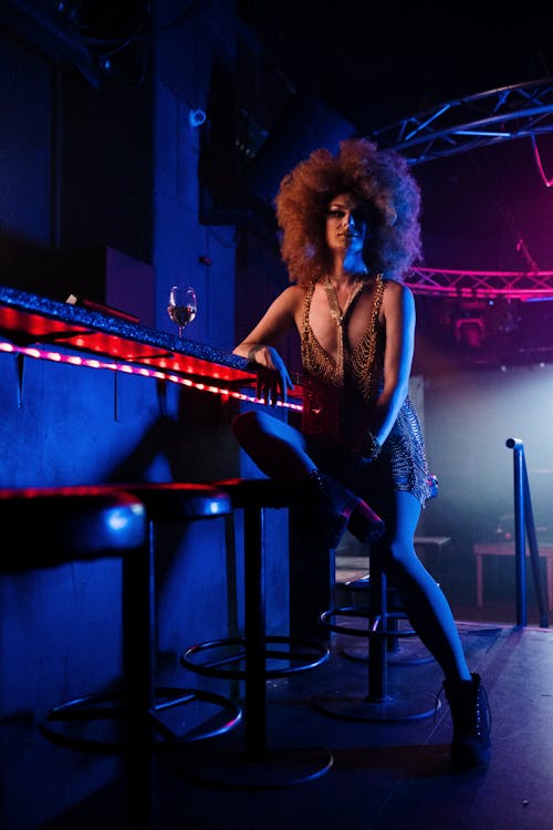 Drag Queen Sitting at a Bar