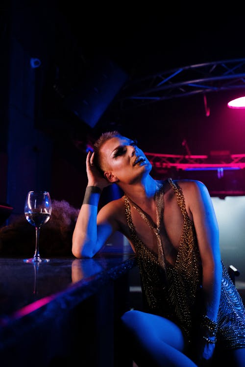 Drag Queen Sitting at a Bar