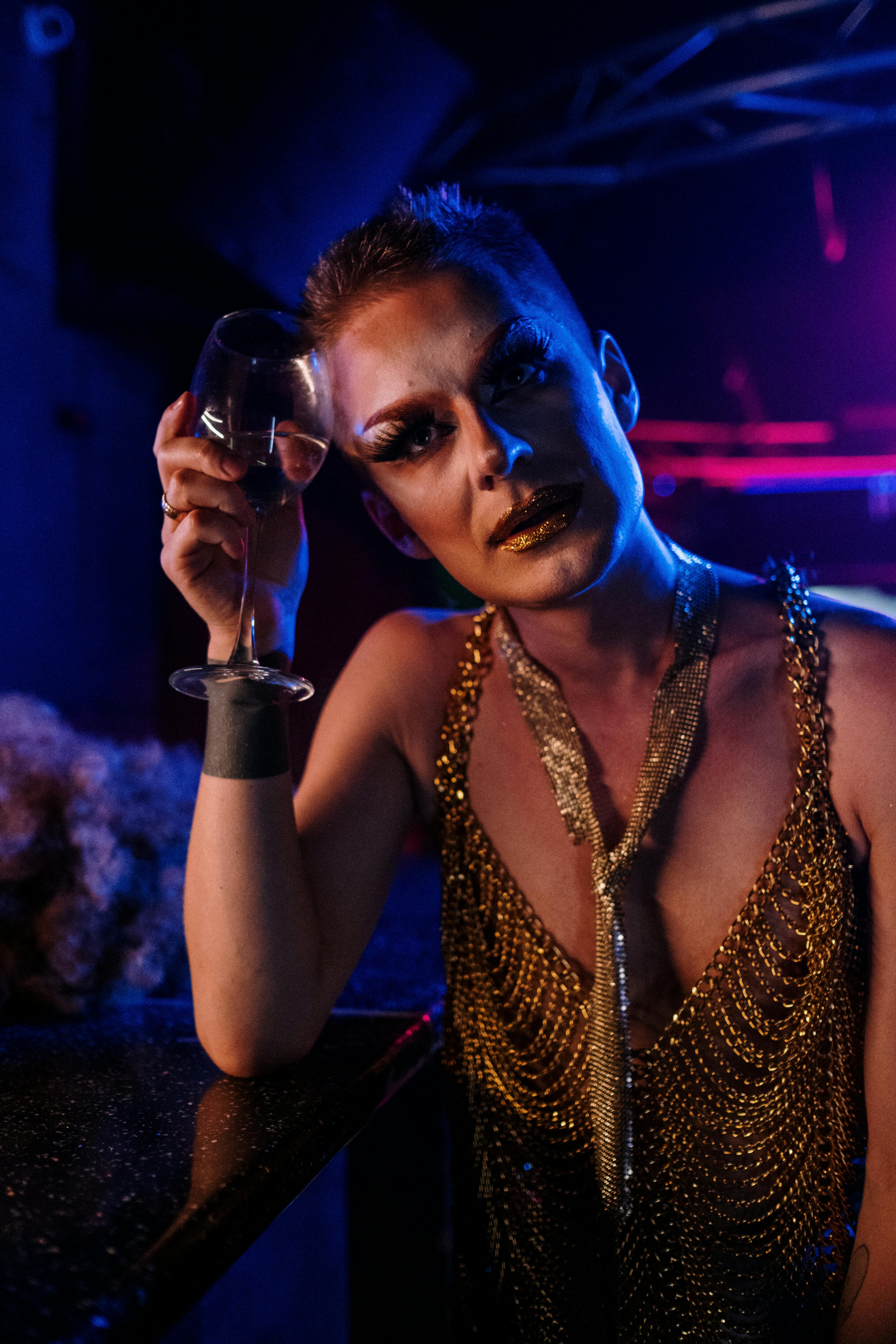 drag queen holding a wine glass