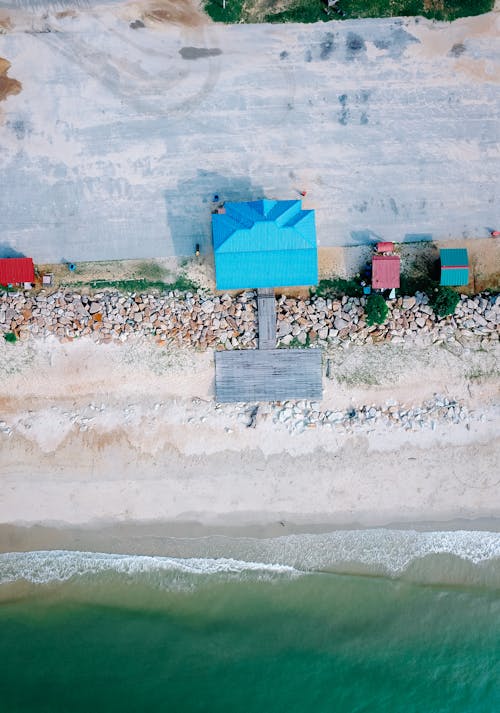 Sandy beach of ocean with colorful houses