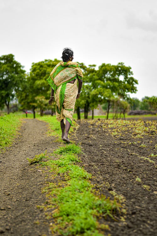 Woman Walking on Farmland