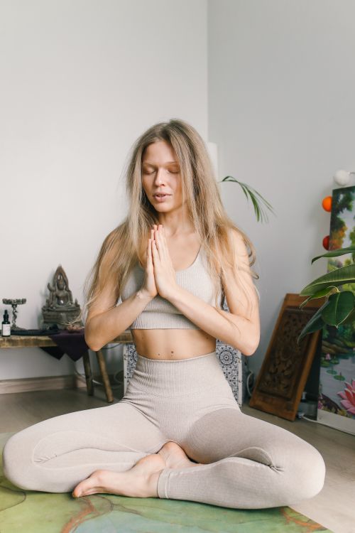 Free A woman in activewear practices yoga meditation indoors, radiating calm and relaxation. Stock Photo