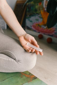 A woman sitting in meditation holding a crystal, fostering relaxation and inner peace.