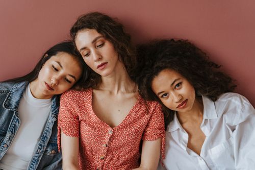 Free A diverse group of women sitting and leaning together, showcasing friendship and unity. Stock Photo