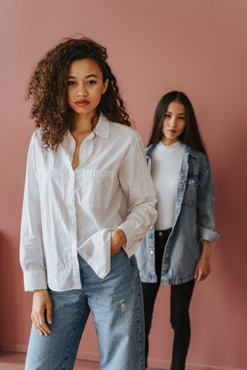 Free 2 Women in White Dress Shirt and Blue Denim Jeans Stock Photo