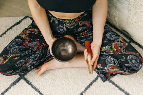 Free Person Sitting Holding Tibetan Singing Bowl  Stock Photo