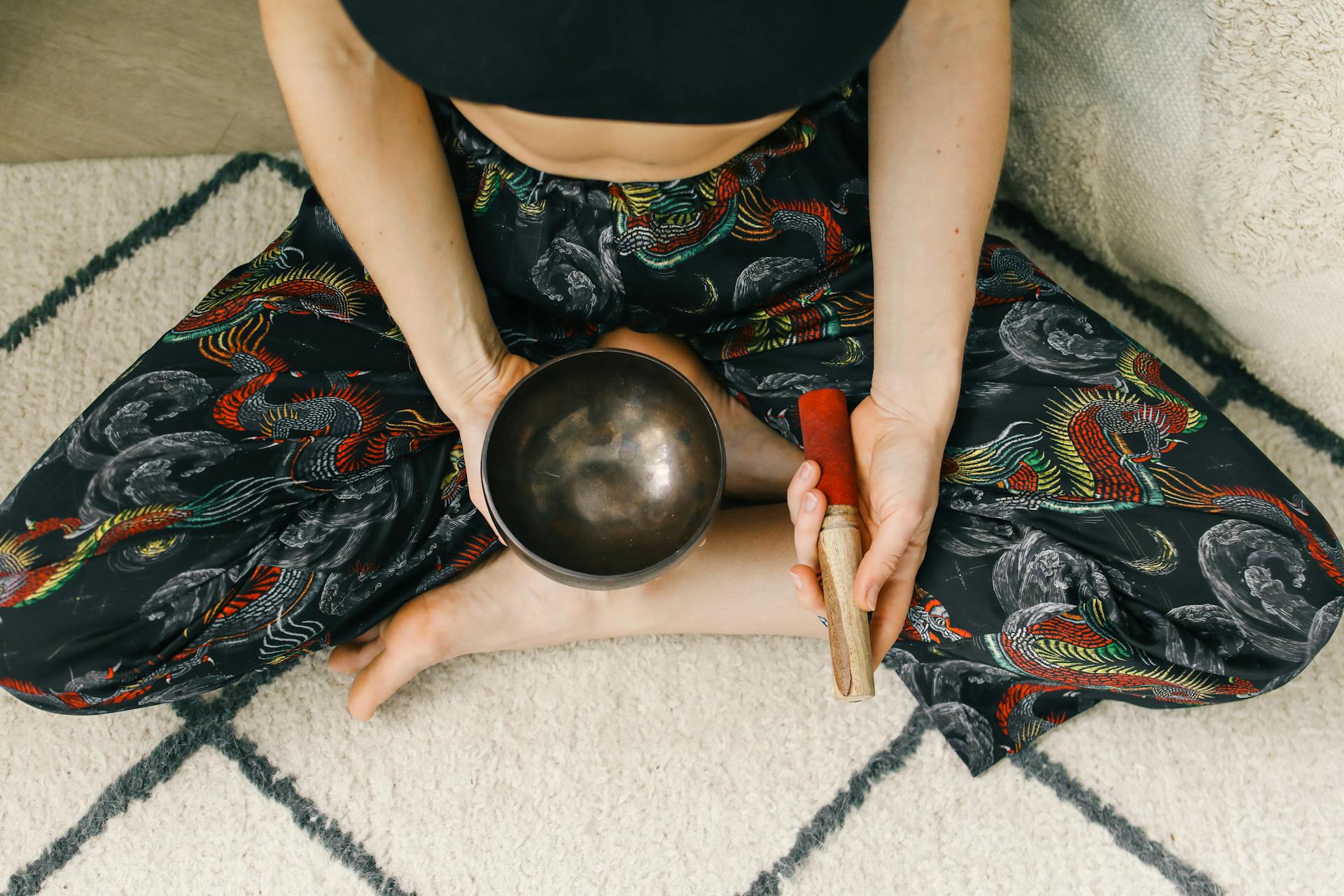 Person Sitting Holding Tibetan Singing Bowl