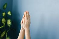 Persons Hand on White Wall