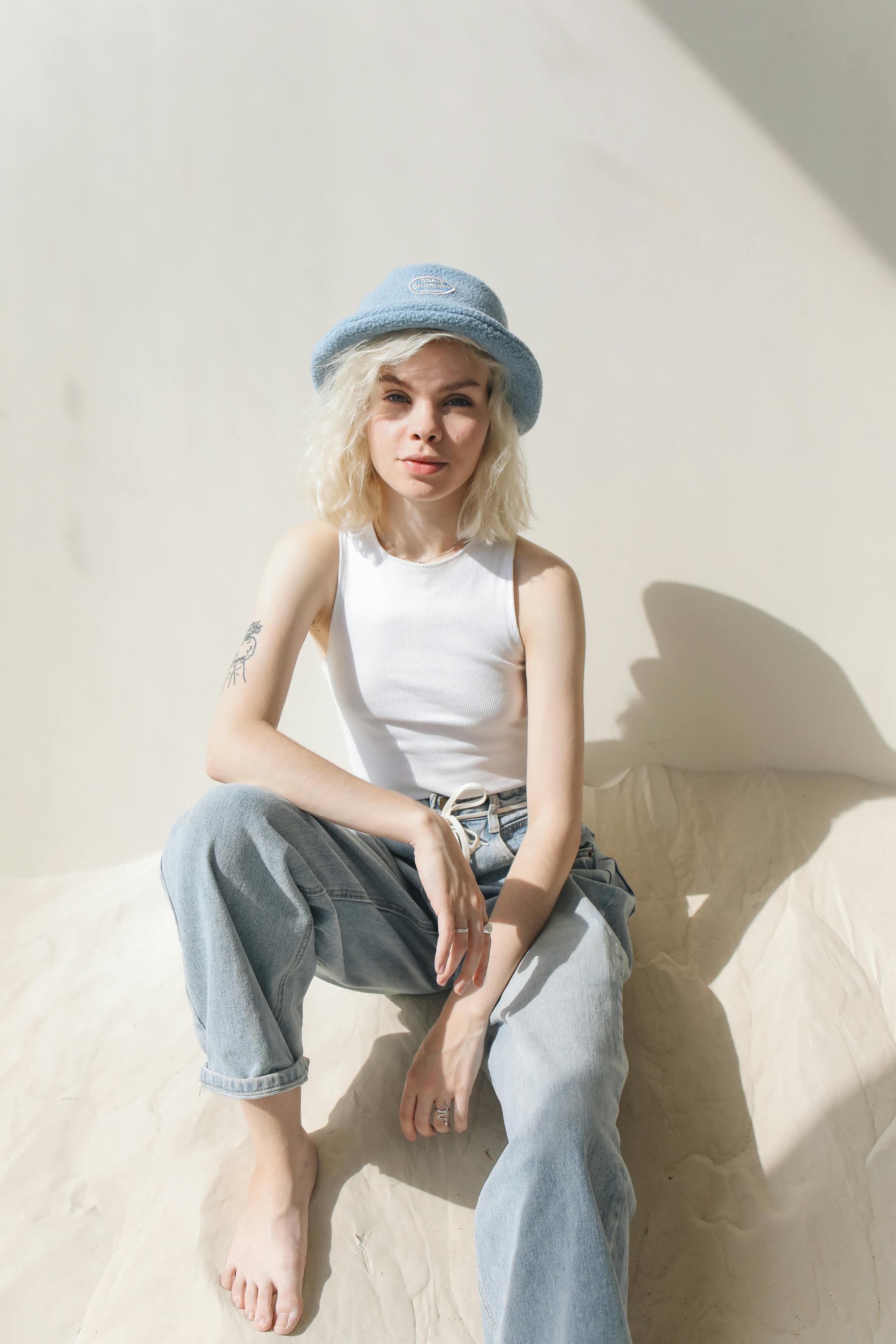 girl in white top wearing blue knit cap