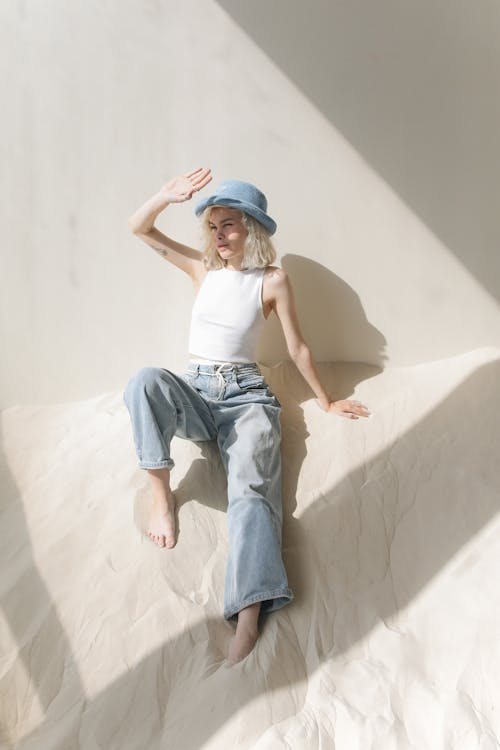 Free Woman in White Top and Blue Denim Jeans Stock Photo