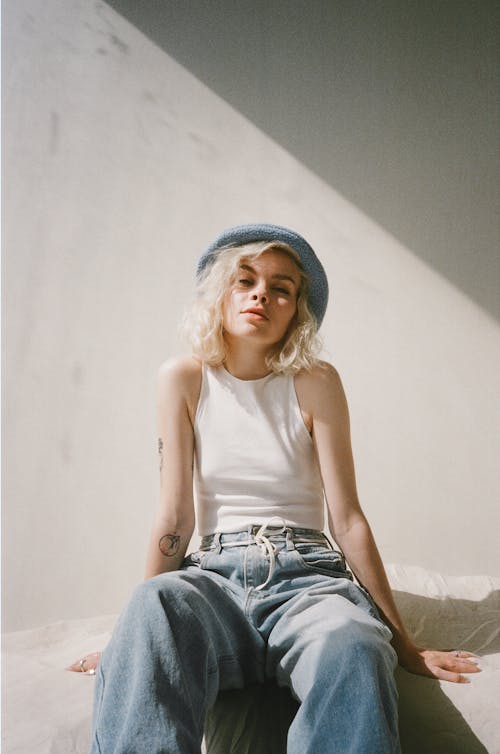 Woman in White Top and Blue Denim Jeans