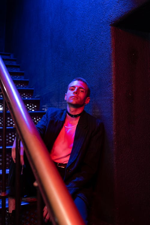 Man in Black Suit Jacket Sitting on Stairs