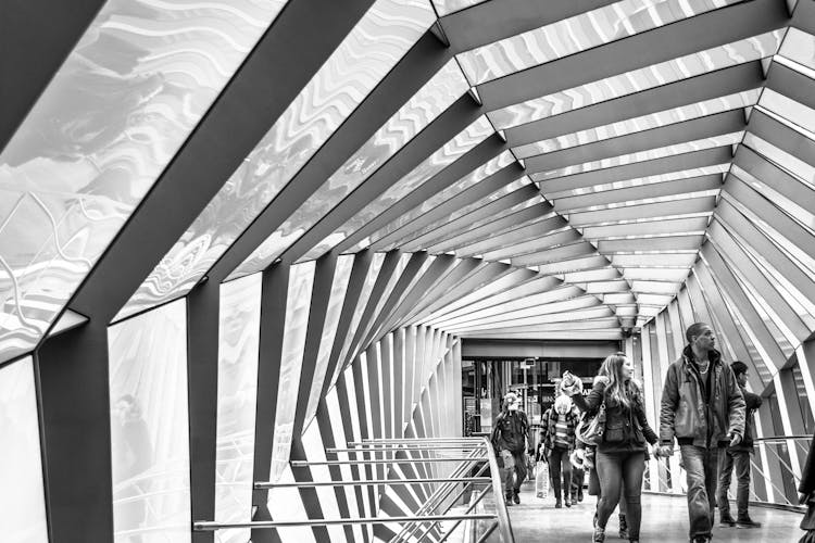 Group Of People Walking On Floor In Modern Building