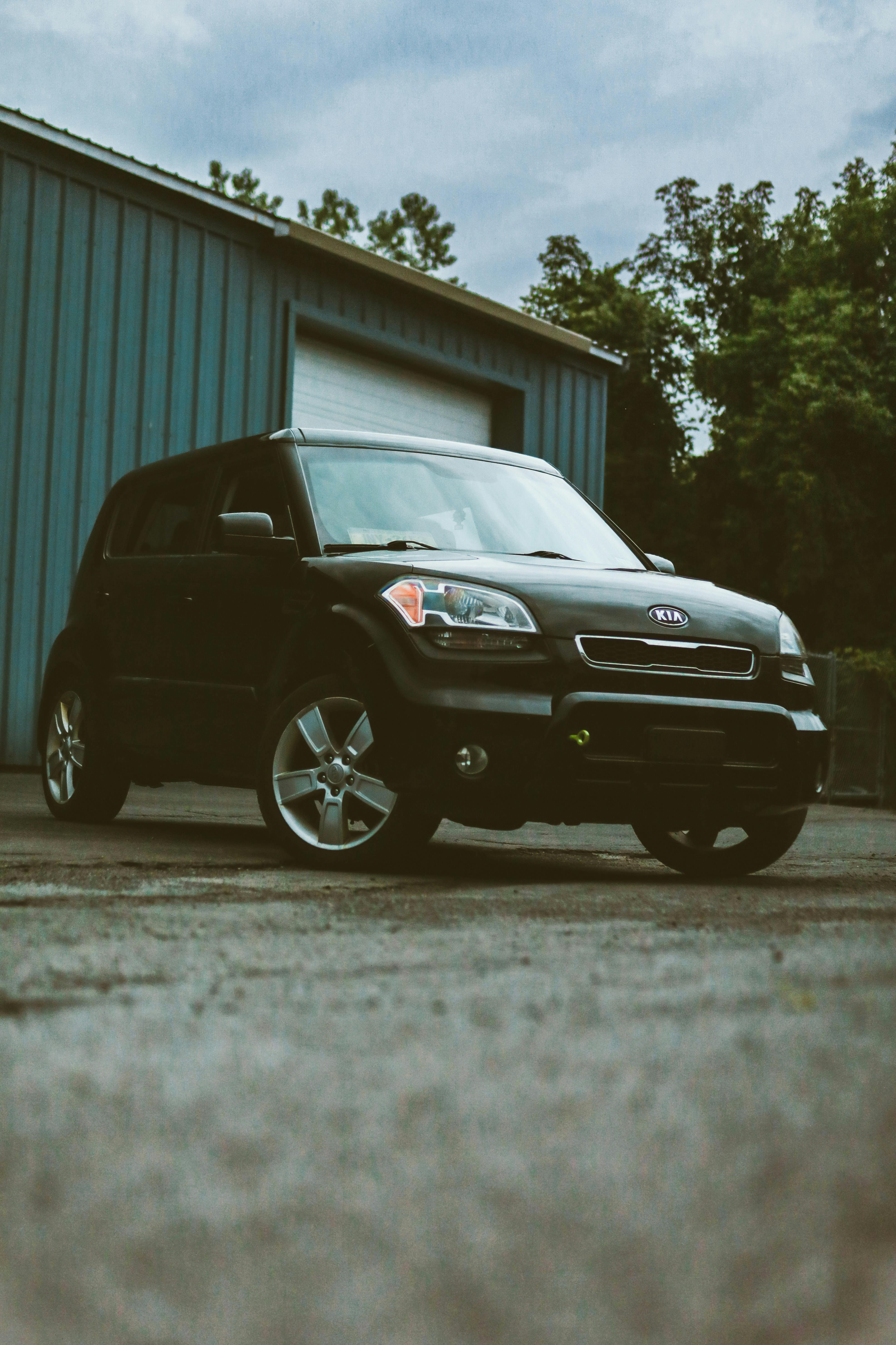 Black Chevrolet Suv Parked Beside Gray Wall · Free Stock Photo