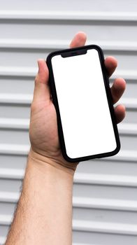 Close-up of a hand holding a smartphone with a blank screen, ideal for mockup use.