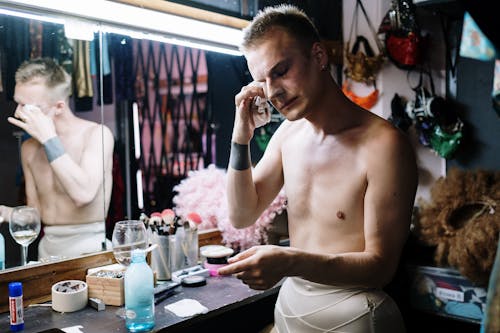 Topless Man Removing Makeup
