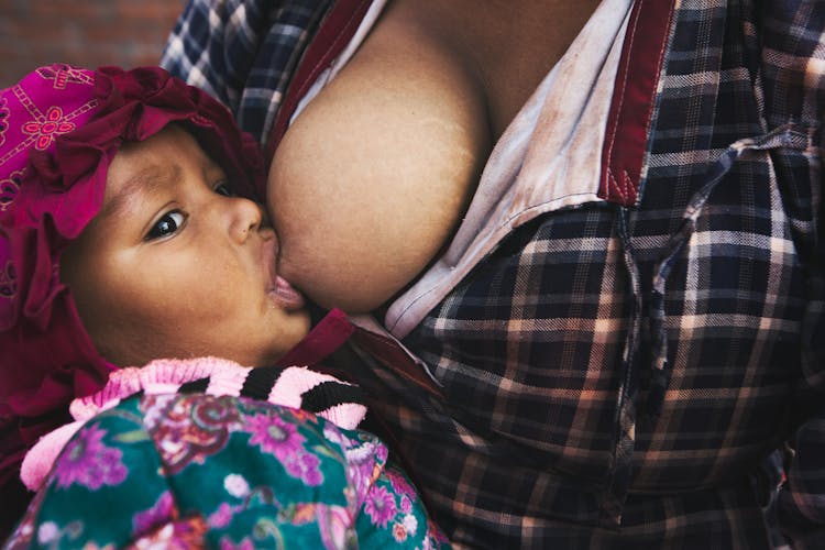 Close Up Photo Of Baby Breastfeeding