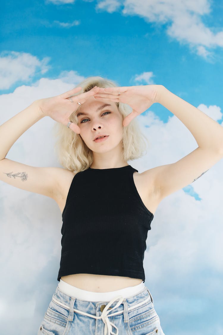 Woman In Black Tank Top Raising Her Hands