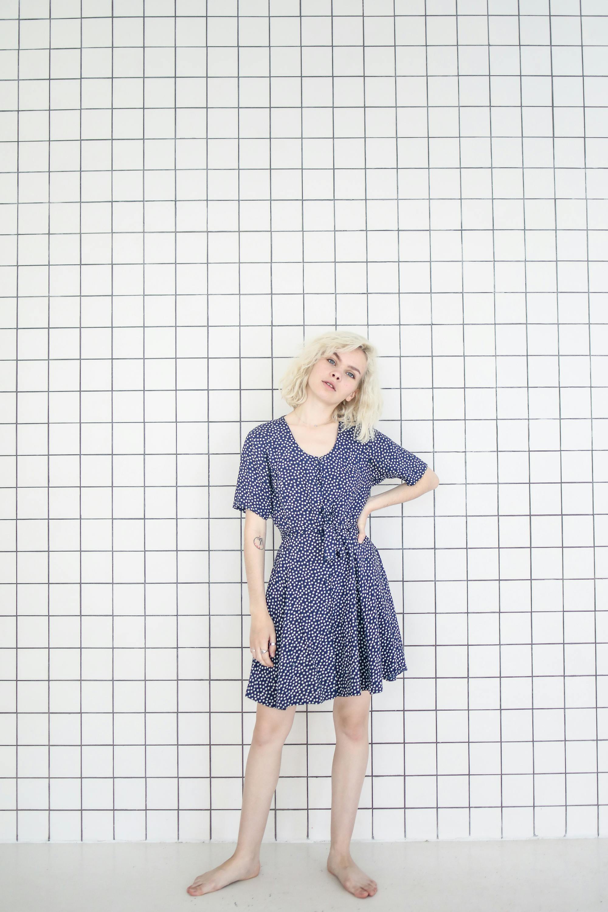 photo of woman in blue dress standing