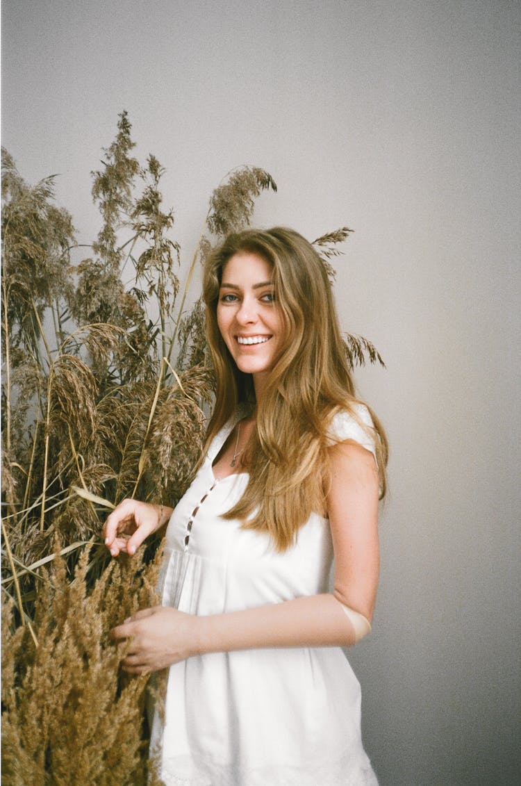 Happy Person Standing Beside Dried Plants